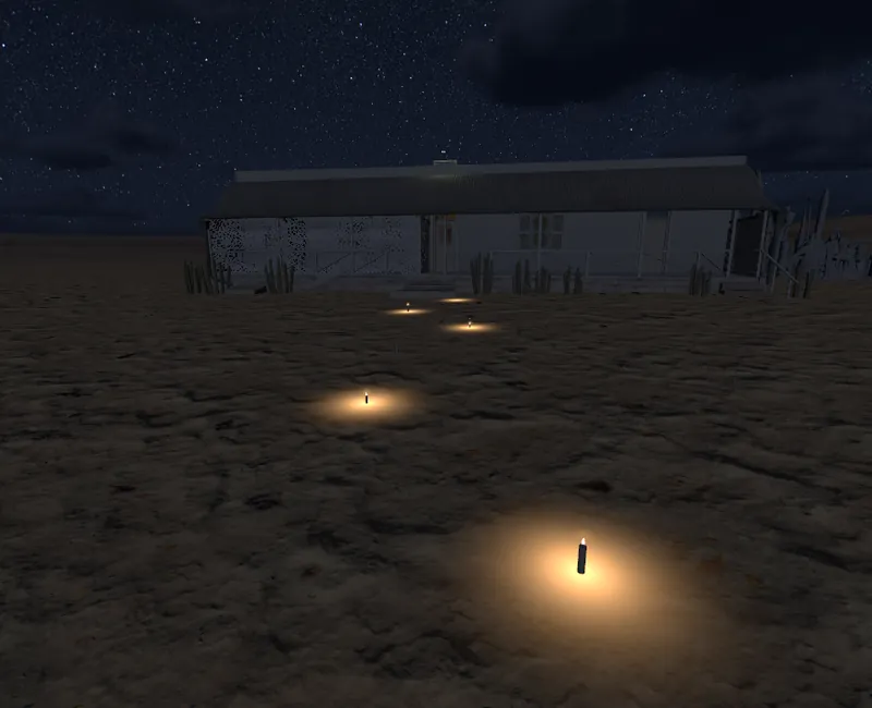 The Owl House at night, with a row of lit candles on the sand leading to the front stoep